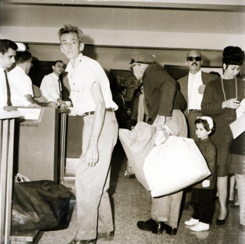 un niña espera para que le chequeen su documentación en el aeropuerto de varadero. operación peter pan. 1960 1962